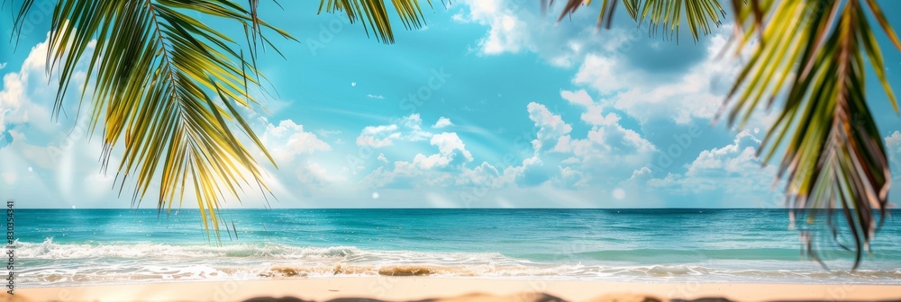 Fototapeta premium Beautiful summer background with blurred sandy beach and palm tree leaves on blue sky banner, panoramic banner with copy space for design text