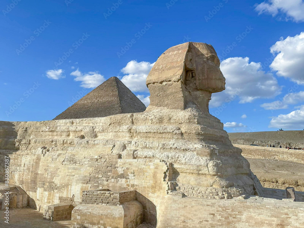 Great Sphinx including pyramids in the background on a clear sunny, blue sky day in Giza, Cairo, Egypt with no people Great Sphinx including pyramids in the background on a clear sunny, blue sky day in Giza, Cairo, Egypt with no people