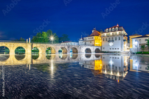 Ponte de Trajano reflected on Tamega river in Chaves, Portugal.. photo