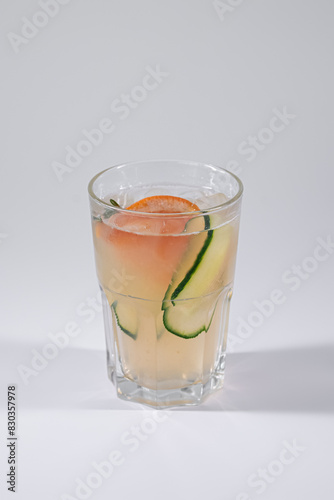 gin fizz cold ice cocktail with grapefruit and cucumber isolated on white
