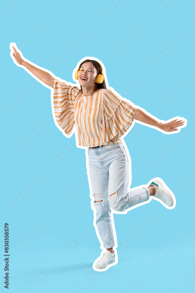 Young Asian woman with painted face in headphones dancing on blue background Young Asian woman with painted face in headphones dancing on blue background