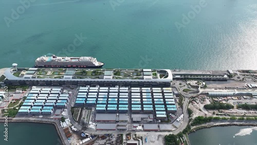 Luxury cruise ship control the position and speed to accurately dock at the Kai Tak Cruise Terminal andl begin berthing operations includes tying down, safety checks, unloading, replenishment  photo