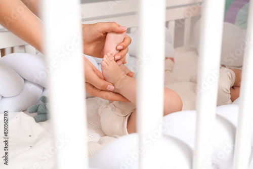 Mother massaging her baby's...