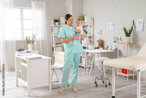 Female pediatrician with little baby in clinic