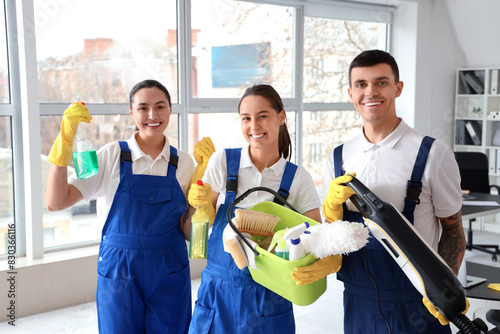 Young janitors with cleanin...