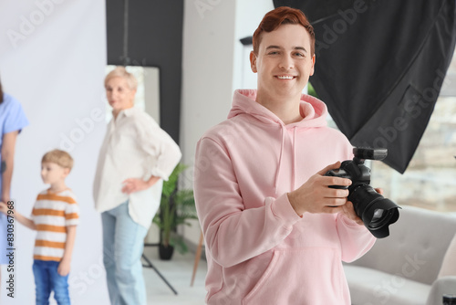 Smiling male photographer h...