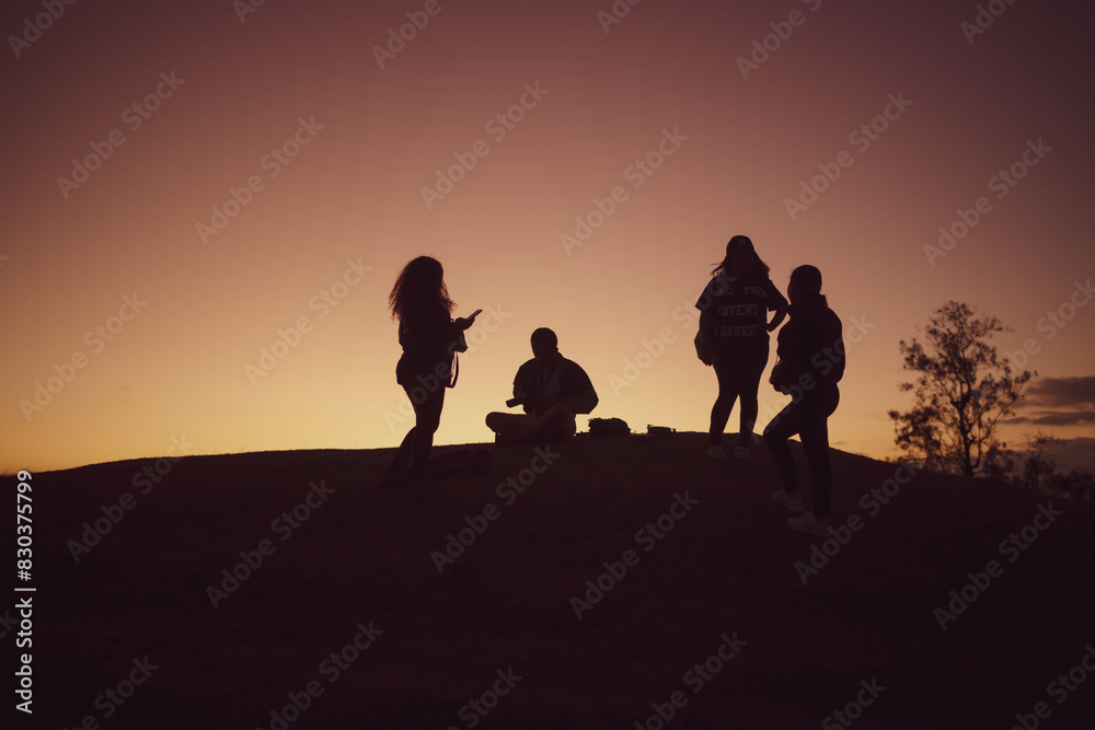 Silhoutte of people on the hill.