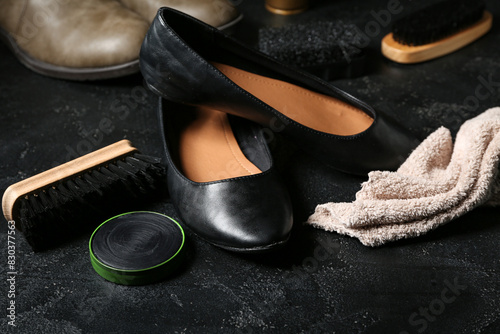 Brush, shoes, cloth and shoe polish on black background