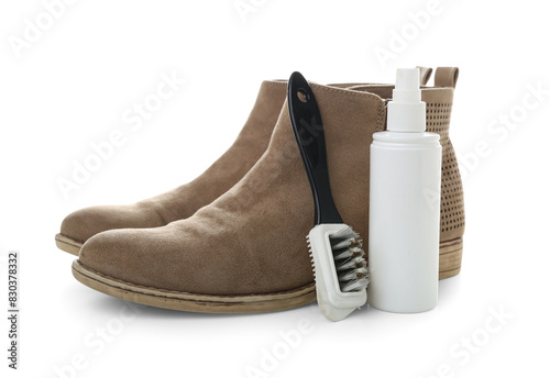 Brush, boots, cleaning spray and shoe polish isolated on white background