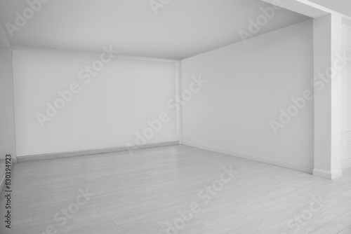 Empty room with white walls and laminated floor
