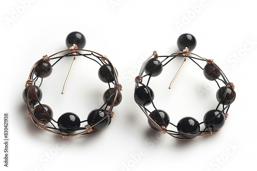 Wire earrings with black beads isolated on white background.
