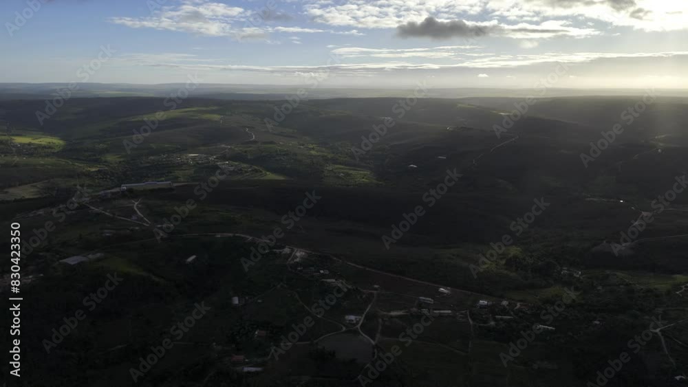 Drone flies backwards over rolling green hills at sunset Drone flies backwards over rolling green hills at sunset