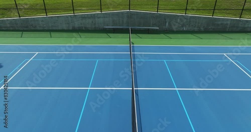 Drone, aerial, video over new blue tennis courts with white lines and light blue pickleball lines
