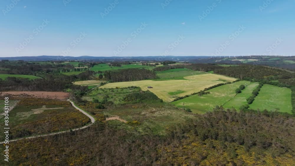 Panoramic View Over Countryside Landscape With Tractor Working On Agricultural Field - Drone Shot