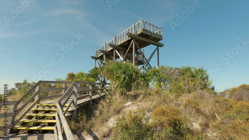 Panning up view of the Hobe Mountain observation tower, site of WWII army training facility at Jonathan Dickinson State Park in Florida. photo