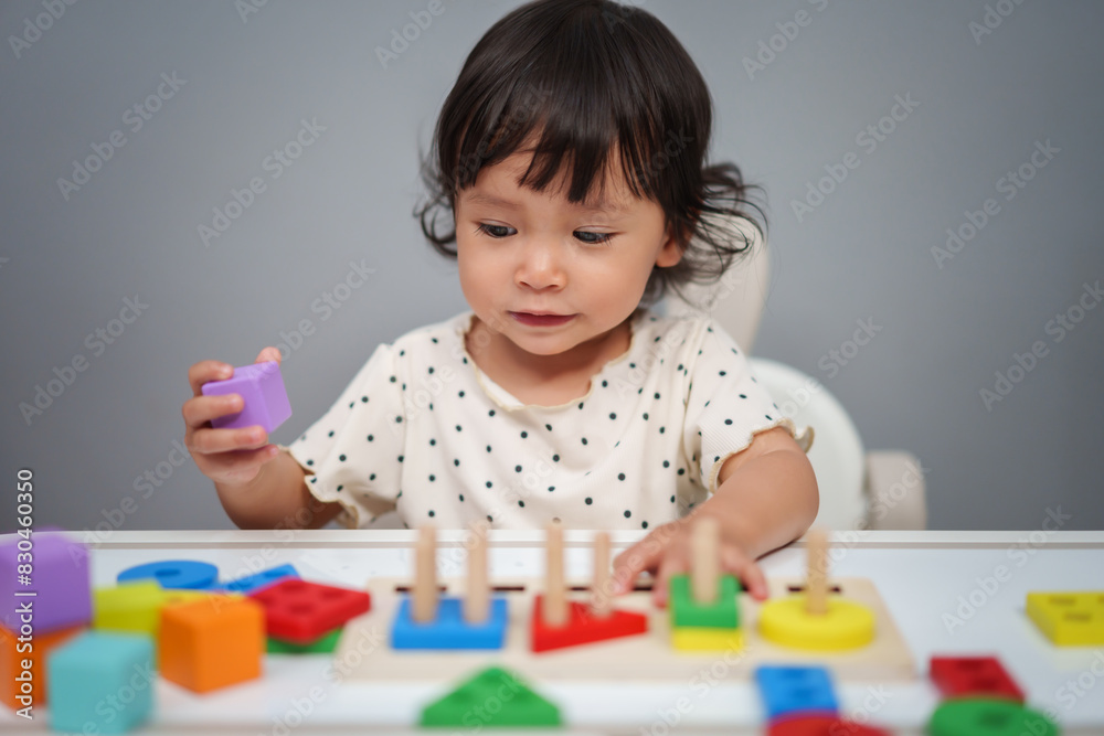 toddler baby girl playing with wooden educational geometric on table toddler baby girl playing with wooden educational geometric on table