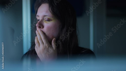 Shocked and scared Woman looking at her bruised eye in mirror in slow motion. Domestic Violence Victim photo