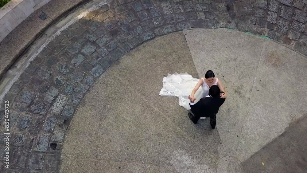 Aerial shot in Bird eye view of hispanic newlyweds dancing and in love Aerial shot in Bird eye view of hispanic newlyweds dancing and in love