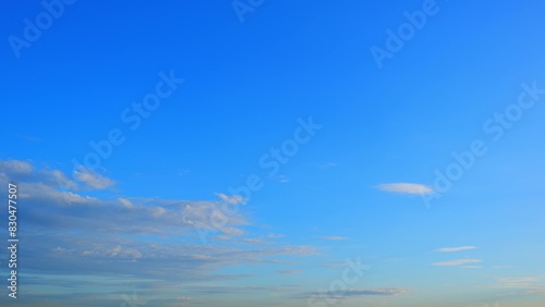 A beautiful sunrise with a clear blue sky. Some scattered clouds are visible  reflecting the soft morning light  adding depth and a serene ambiance to the scene. Sunrise sky background. 