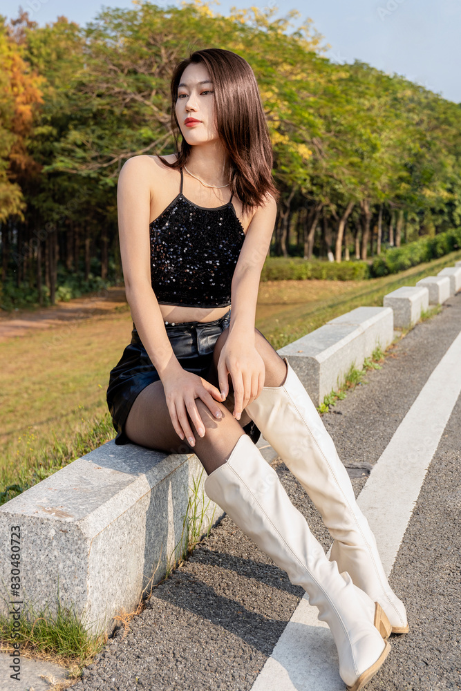 A spirited beauty wearing leather pants and a strapless skirt A spirited beauty wearing leather pants and a strapless skirt