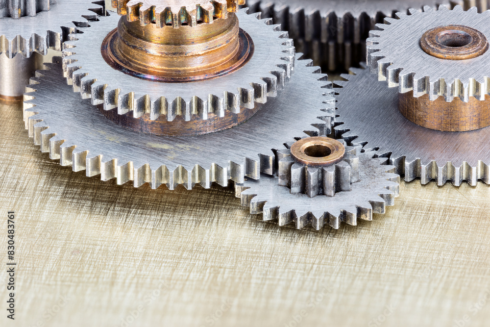 various cogwheels for industrial machines. macro view on scratched brass background. various cogwheels for industrial machines. macro view on scratched brass background.