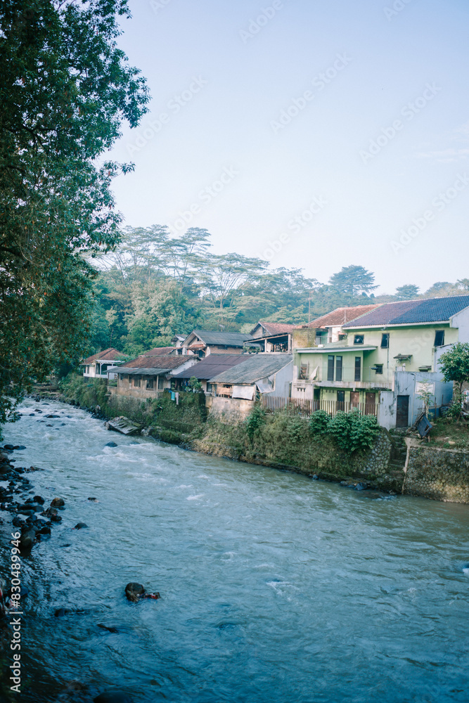 The Ciliwung River in Bogor, flowing through lush greenery and urban landscapes. The Ciliwung River in Bogor, flowing through lush greenery and urban landscapes.