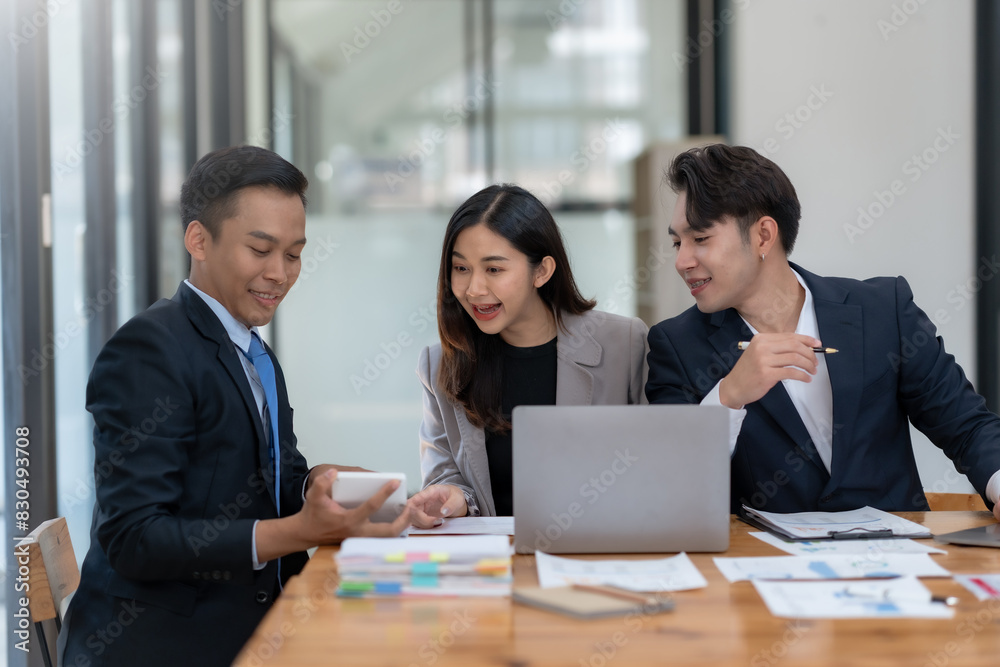 Business team discussing project in modern office, analyzing documents on laptop. Professional collaboration and teamwork concept. Business team discussing project in modern office, analyzing documents on laptop. Professional collaboration and teamwork concept.