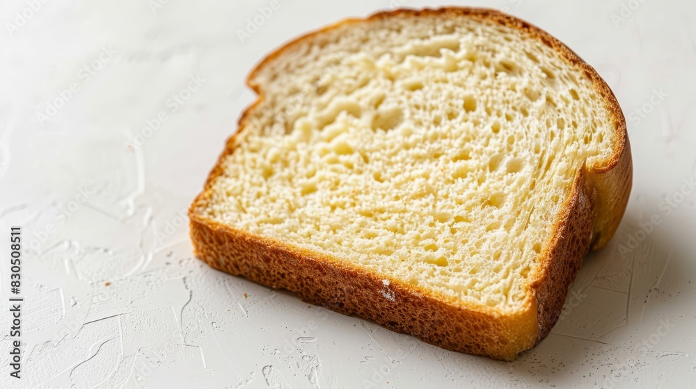 A slice of white bread on a pristine countertop Adjacent, another slice with taken bites A slice of white bread on a pristine countertop Adjacent, another slice with taken bites