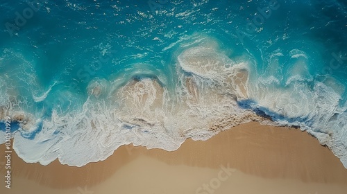  An aerial perspective reveals a beach with an incoming wave  a boat in the water  and a sandy shoreline