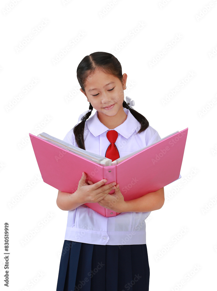 Portrait of Asian schoolgirl in elementary school uniform standing with holding open hard book isolated on white background. Image with Clipping path. Portrait of Asian schoolgirl in elementary school uniform standing with holding open hard book isolated on white background. Image with Clipping path.