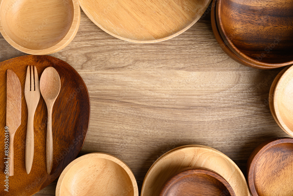 Kitchen utensils, wooden bowl, plate, dish, spoon and fork on wooden background, Table top view Kitchen utensils, wooden bowl, plate, dish, spoon and fork on wooden background, Table top view