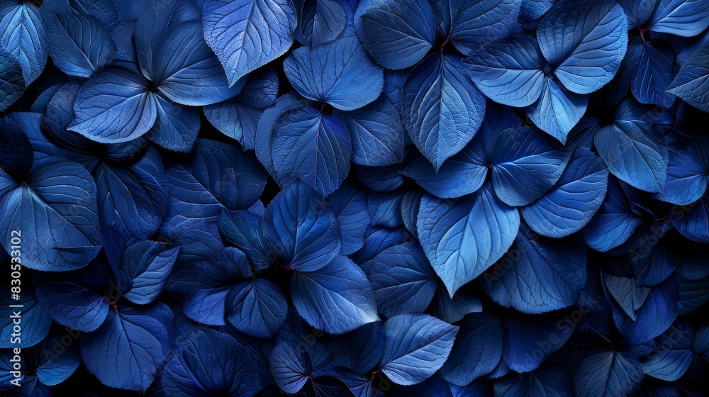 A bunch of blue leaves, all shaped identical, with each possessing a bluish hue A bunch of blue leaves, all shaped identical, with each possessing a bluish hue