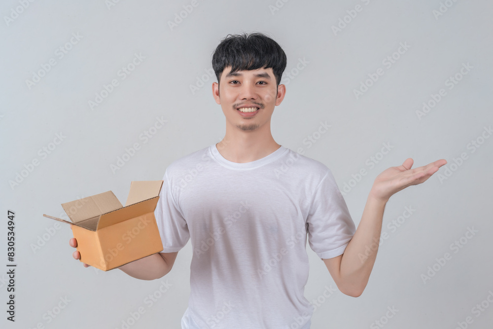 Handsome young man holding parcel box and with happy smile face. Handsome young man holding parcel box and with happy smile face.