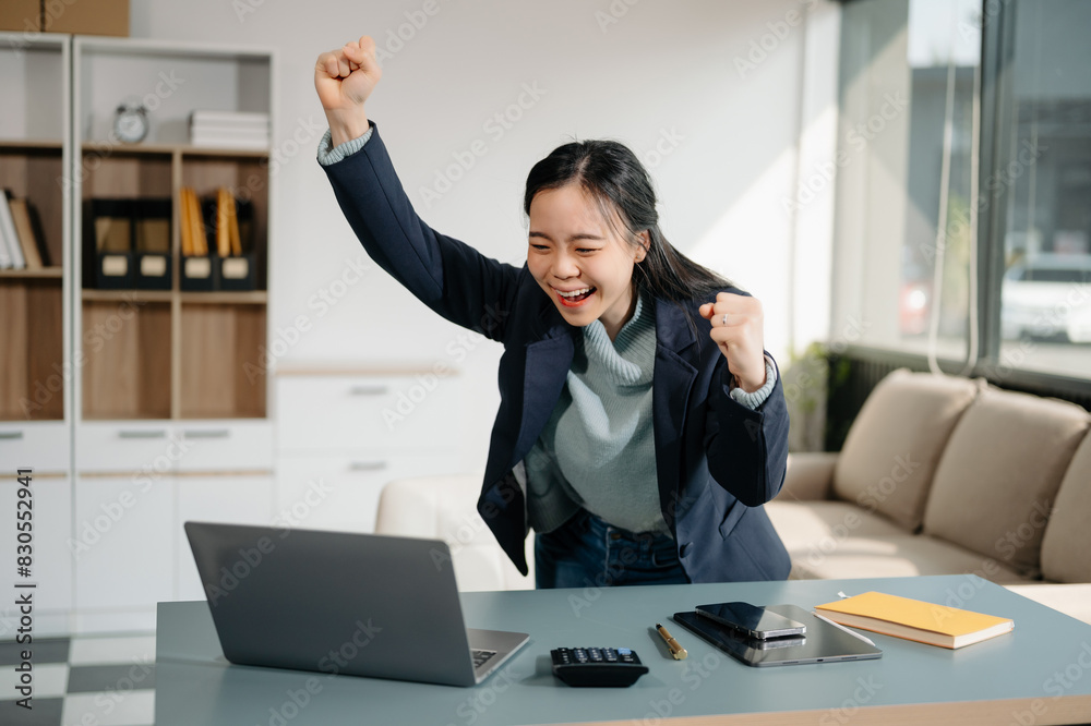 Asian business woman are delighted and happy with the work they do on their tablet, laptop and taking notes Asian business woman are delighted and happy with the work they do on their tablet, laptop and taking notes
