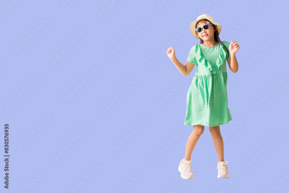 Happy smiling asian little girl and jumping, dancing were hat and sunglasses posing, Fashion summer holiday concept, Full body isolated on purple background Happy smiling asian little girl and jumping, dancing were hat and sunglasses posing, Fashion summer holiday concept, Full body isolated on purple background
