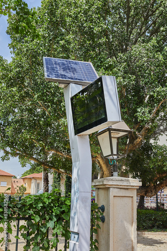 A board showing the bus schedule at a city stop, powered by a solar battery