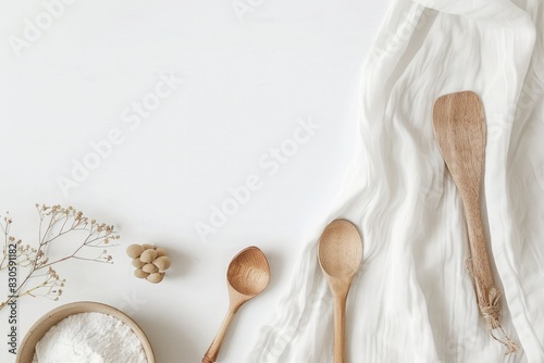A set of wooden kitchen utensils including spoons, forks, and spatulas on a wooden table photo