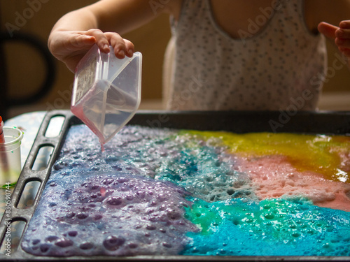 a child makes experiments with chemicals. experiments with soda and citric acid
