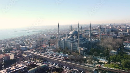 Aerial footage showcasing the iconic Blue Mosque in Istanbul, Turkey, with its majestic domes, minarets, surrounded by the cityscape and historic landmarks. Istanbul, Turkey - İstanbul, Türkiye photo