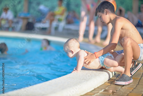 A small child near the pool without adult supervision, danger.