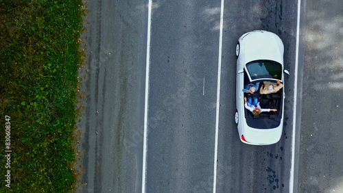 Cuadro en lienzo Aerial top view of white convertible car driving through empty rural road