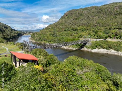 Bridge crossing the grey river at the  abandoned historic Brunner Mine, Greymouth, West Coast, New Zealand. photo