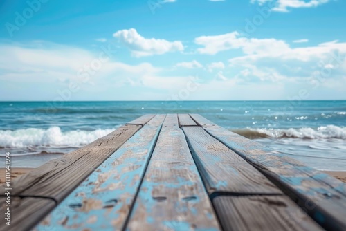 Weathered Wooden Pier Leading to the Ocean on a Sunny Day with Blue Sky  © Xkerz