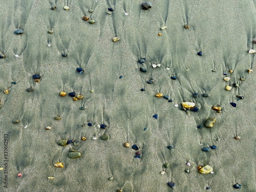 a collection of small rocks on the beach