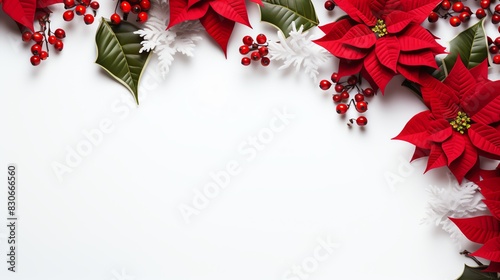 Festive Christmas background with red poinsettia flowers, berries, and green leaves on a white surface. Ideal for holiday themes.