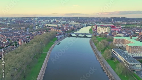 A flight along the River Trent, whose still water reflects the late sunset sky. A Trent Bridge is seen in the background, Nottingham, England photo