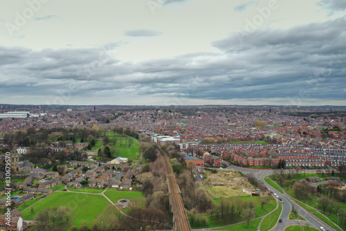 Aerial photo of the village of Kirkstall in the Leeds city centre in the UK over looking rows of terrace houses and a train track viaduct in the West Yorkshire city centre