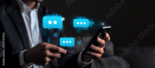 Wallpaper Mural A businessman using smartphone and virtual blue chat bubble icons Torontodigital.ca