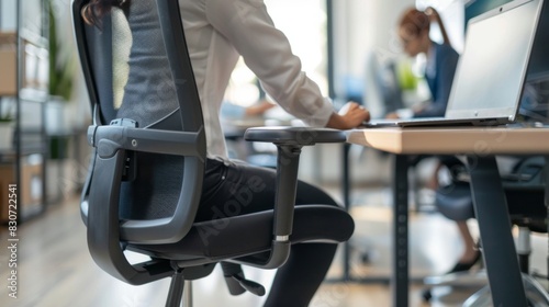 Wallpaper Mural Office Worker Adjusting Ergonomic Chair and Desk Setup Torontodigital.ca