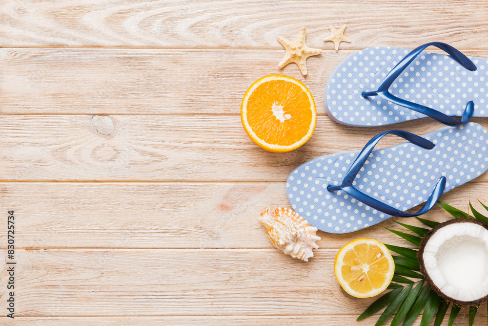 Top view composition of flip flops placed with beach accessories top view on table background. Tropical summer vacation concept Flat lay Top view composition of flip flops placed with beach accessories top view on table background. Tropical summer vacation concept Flat lay